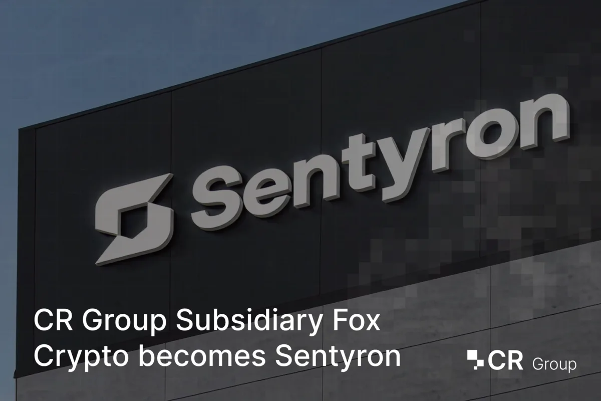 Sentyron logo mounted on a dark building facade, announcing the rebranding of Fox Crypto to Sentyron